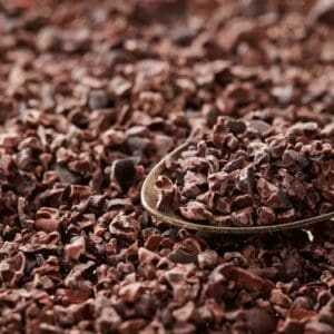 A spoon is laying on the ground of chocolate.